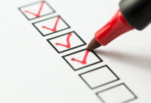 red-felt-pen-ticking-off-boxes-on-checklist